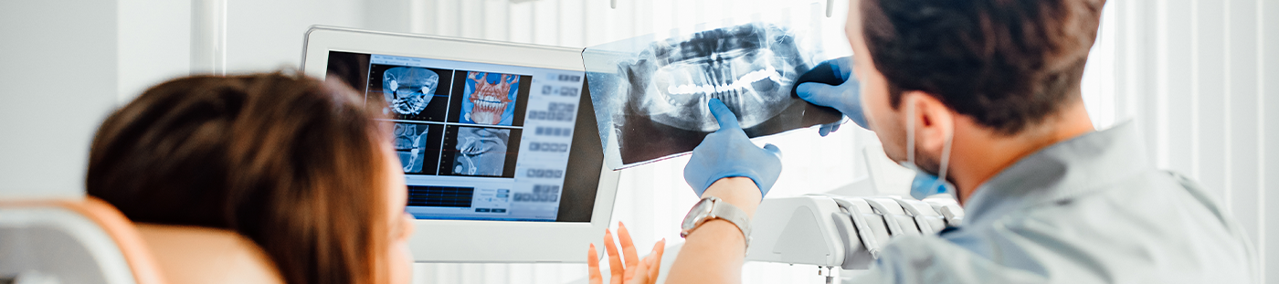 Dentist showing a patient an x ray of their teeth