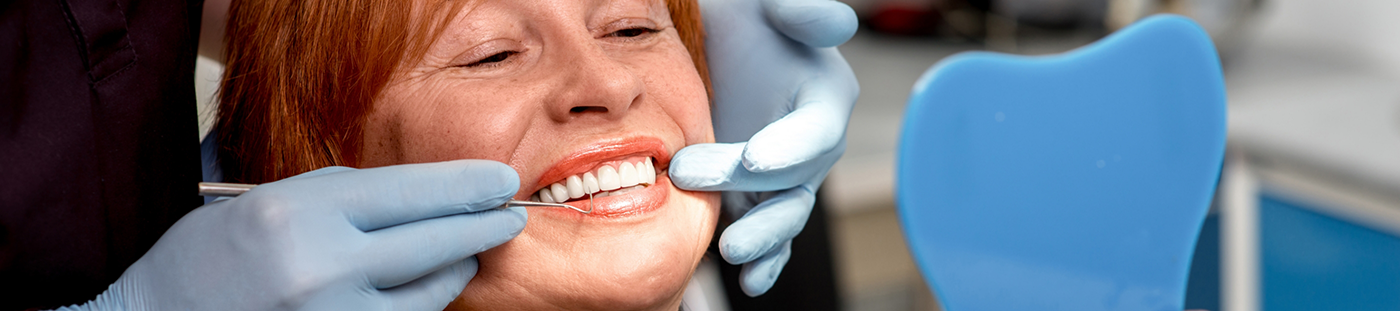 Woman admiring her new smile in mirror