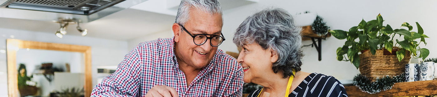 Senior man and woman in their kitchen