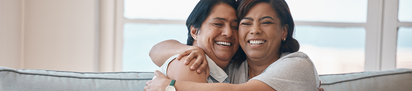 Two people hugging and smiling